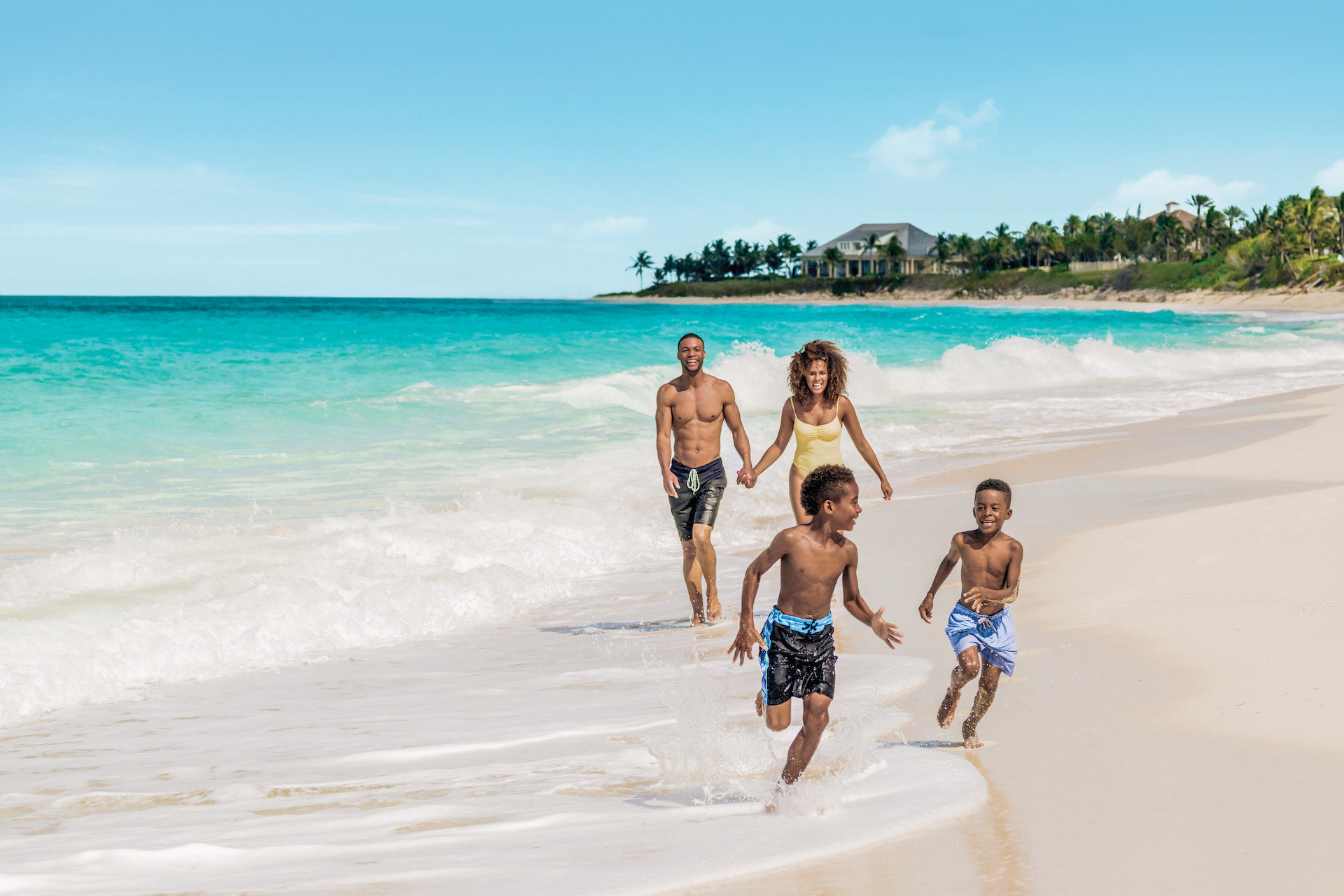 Family running on beach