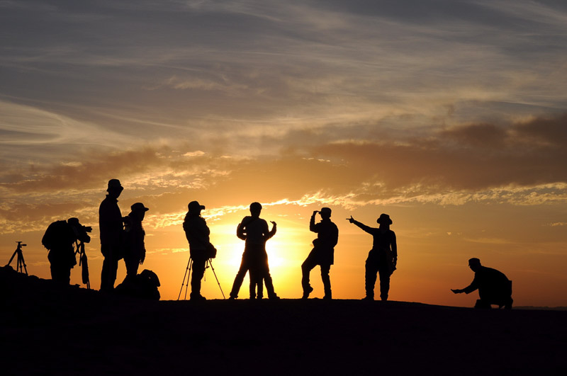 Group travelers during sunrise