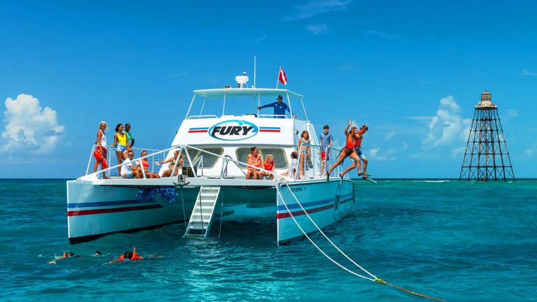 Snorkelers jumping off a boat