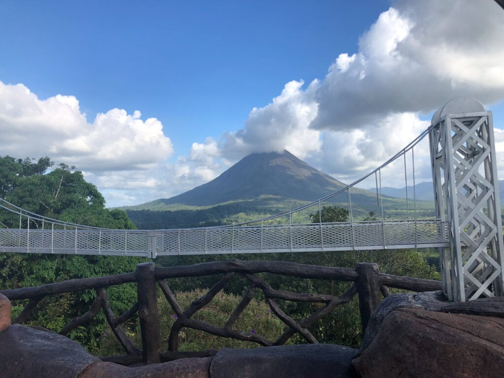 Hanging bridge in with Arenal volcano in the background