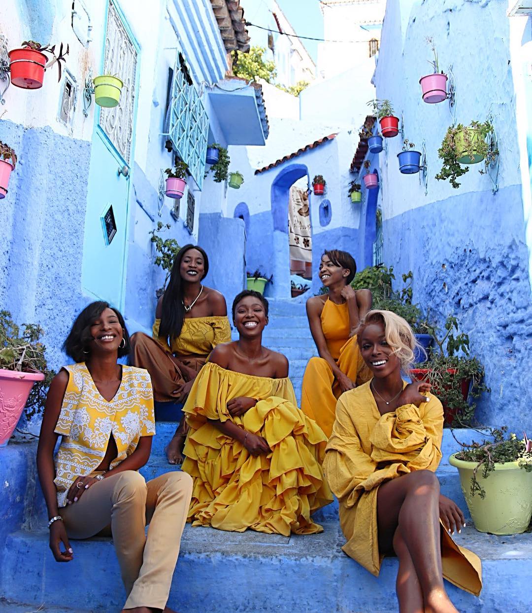 Group of women travelers sitting on stairs