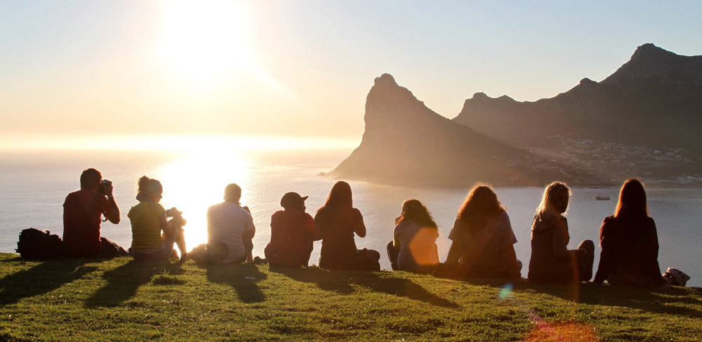 Travel group watching the sunset